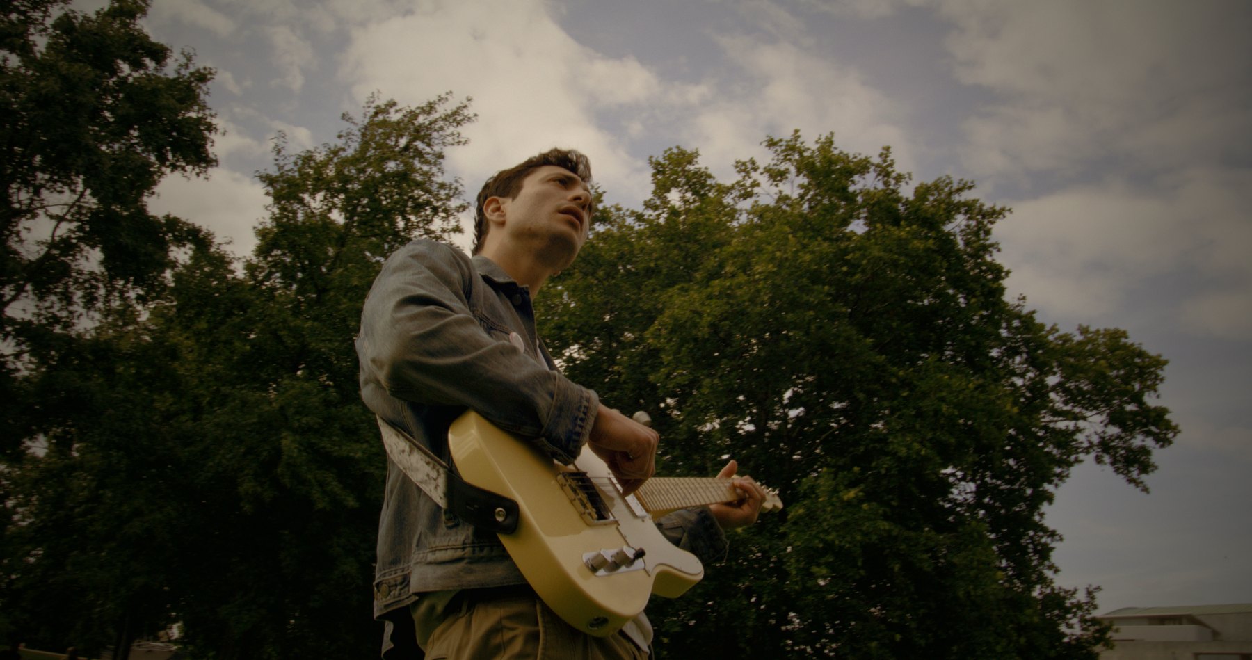Guitar-first, no audience but the trees.